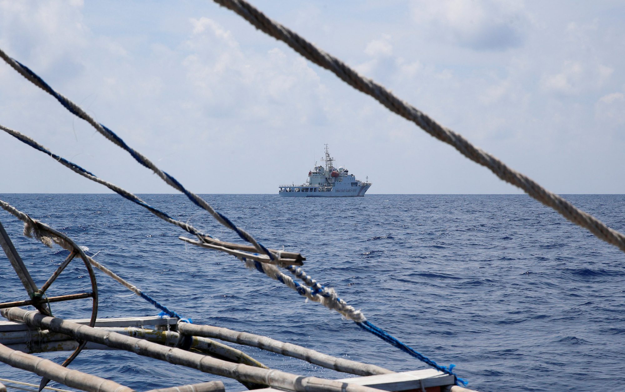 FILE PHOTO: A China Coast Guard ship is seen from a Philippine fishing boat at the disputed Scarborough Shoal April 6, 2017. Picture taken April 6, 2017. REUTERS/Erik De Castro/File Photo