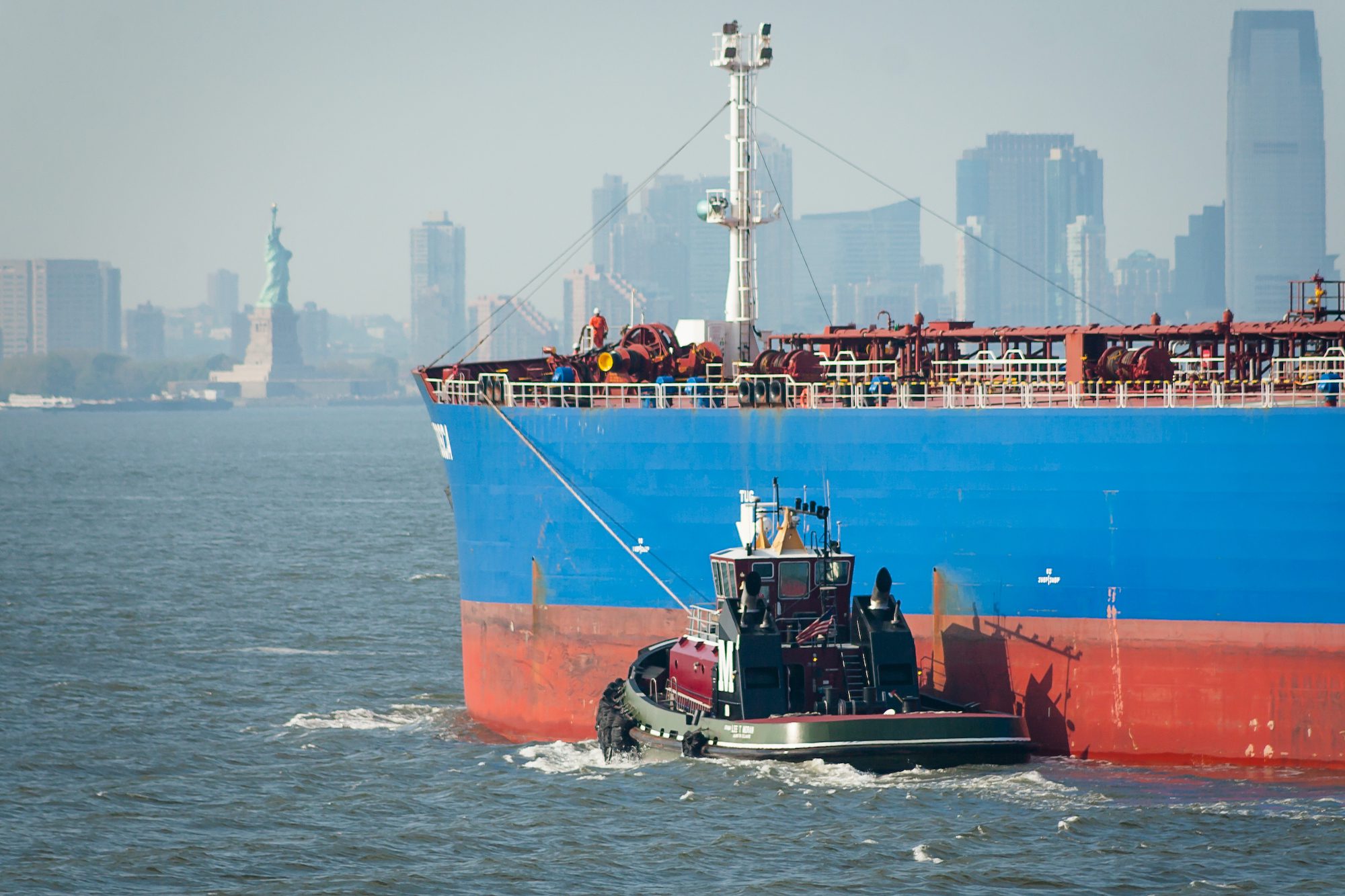 Stock photo of a tanker being escorted by a tug in New York harbor